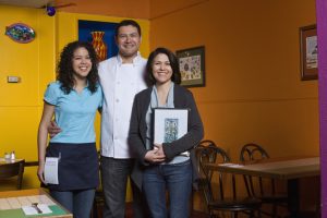 family portrait of small business owners. mexican restaurant owners